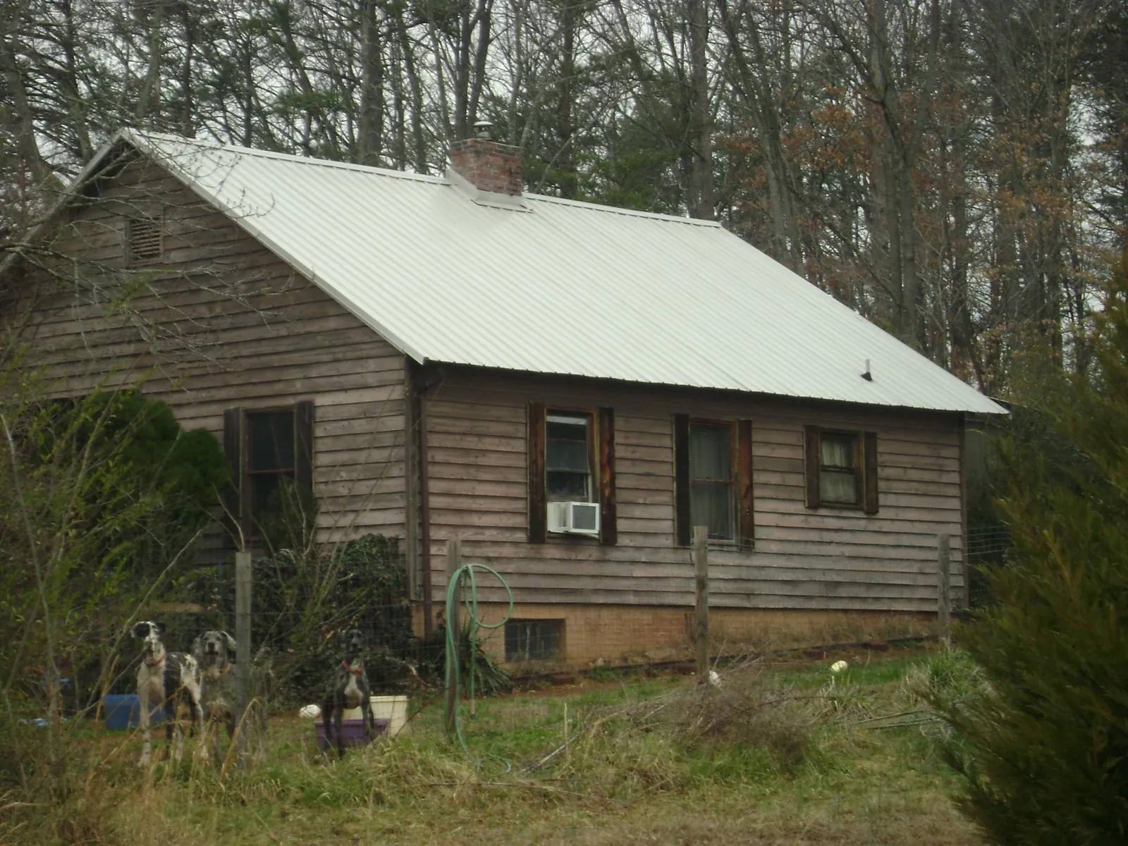 White metal roof on an old wood sided farmhouse, from a Metal Roof Installation job in Seal Rock